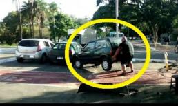 Người đàn ông dùng tay không nâng xe hơi 