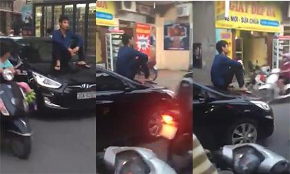 Thanh niên ngồi chễm chệ trên mui xe dạo phố