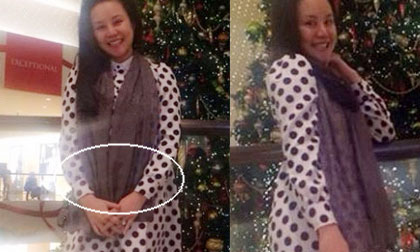 Vy Oanh dùng khăn che bụng bầu lùm lùm