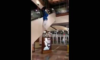 Hậu quả cho anh chàng thích đu ngoài thang cuốn