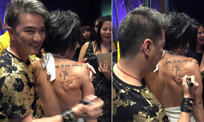 Đàm Vĩnh Hưng ôm thân mật và kí tặng lên lưng trần một fan nữ