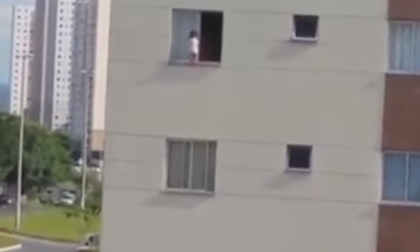 Thót tim cảnh em bé chơi đùa sát mép cửa sổ nhà cao tầng